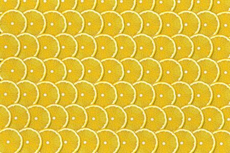 yellow background of sliced lemons closeupの写真素材