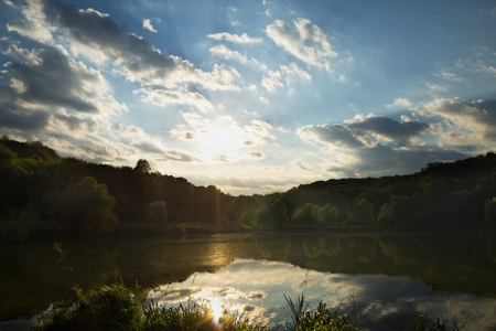 beautiful cloudy sunset over the lakeの写真素材