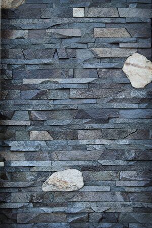 background decorative wall built of gray stone closeupの写真素材