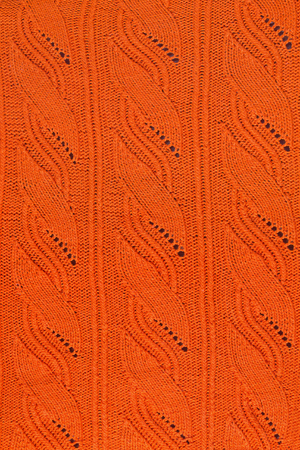 texture of an orange knitted openwork pattern closeupの写真素材