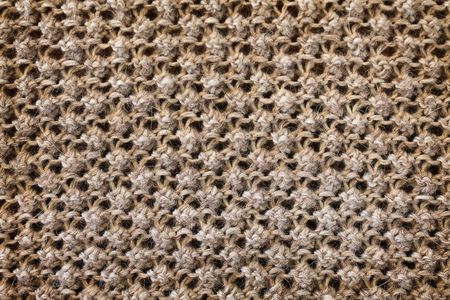 background texture of a knitted fabric with a raised pattern closeupの写真素材