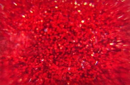 shiny festive blurred red background with sparkles closeupの写真素材