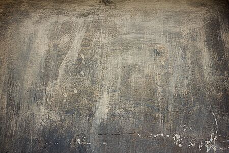 texture of an old gray concrete wall close-up in spots and scratchesの写真素材