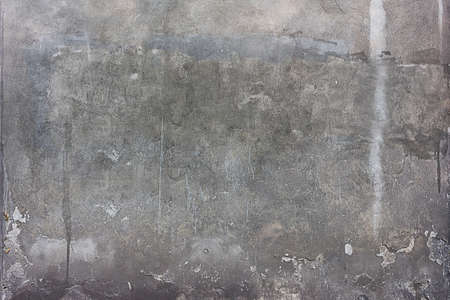 texture of an old gray concrete wall close-up in spots and scratchesの写真素材
