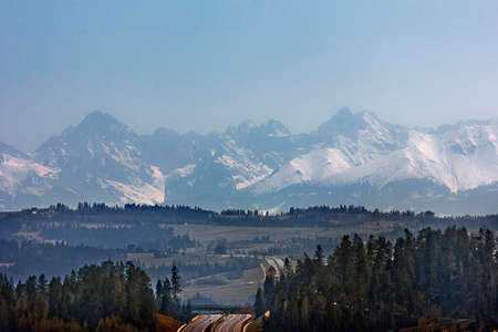landscape with road and snow-capped mountains in the background. Polish Tatrasの写真素材