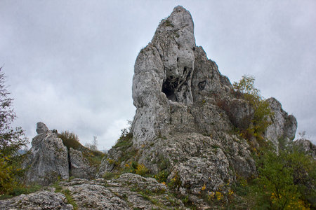 landscape with a rock against a cloudy skyの写真素材