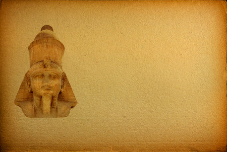 Background close-up of the face of an ancient Egyptian pharaoh on old yellowed paper with copy spaceの写真素材