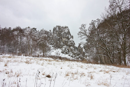 winter landscape with snow-covered rocks. Mountains in winter on a cloudy dayの写真素材