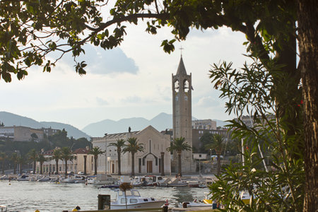 landscape with a small seaside town and mountains in the backgroundの写真素材