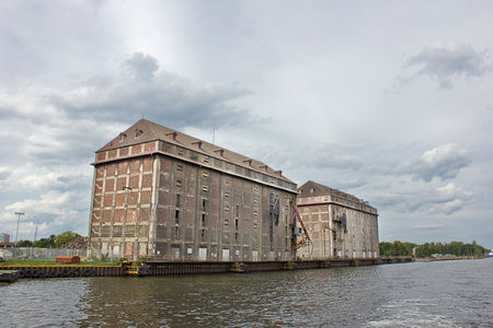 Gdansk, Poland - august 10: two silo buildings at the port on the Mertvaya Vistula River august 10, 2021 in Gdansk, Polandのeditorial素材
