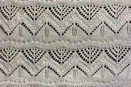 Textured white openwork close-up crochet. White patterned backgroundの写真素材