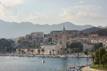 landscape with a small seaside town and mountains in the backgroundの写真素材