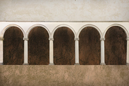 Brown background with row of arches resting on column capitals.の写真素材