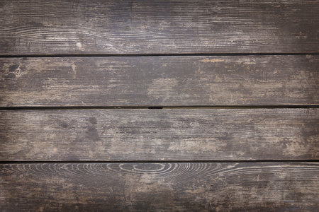 Background wooden planks in close-up. Fence made of old blackened boardsの写真素材