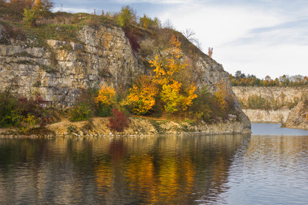 Autumn Landscape. A lake with steep banks and yellow trees on a sunny autumn day.の写真素材