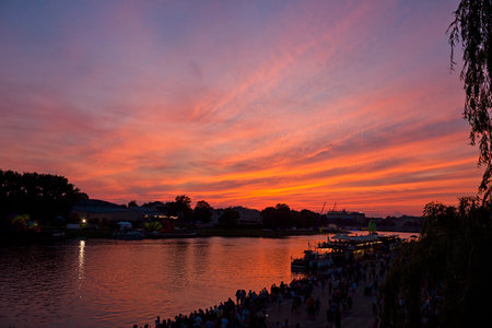 Colorful red sunset on the river. Evening cityscape on the river embankmentの写真素材