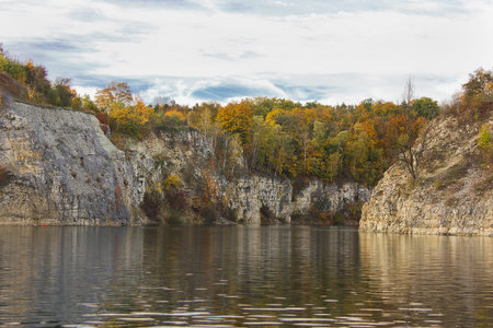 Autumn Landscape. A lake with steep banks and yellow trees on a sunny autumn day.の写真素材