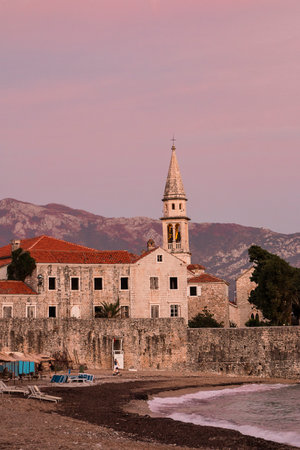 Citadel on the shore of the Adriatic Sea. The ancient 15th century St. Mary's Fortress in Budva, Montenegro.Pink sunset on the sea. Vertical imageの写真素材