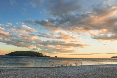 Beach in Budva overlooking the island of St Nicholas. Sunset on the Adriatic Sea.の写真素材