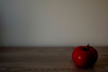 Conceptual background with an tomato and an empty place for inscription, art photoの写真素材