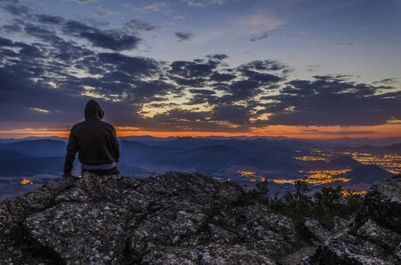 Man waiting the sunrise on the mountain.の写真素材