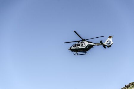 Chopper of Guardia civil patrolling over the mountain in Spainのeditorial素材