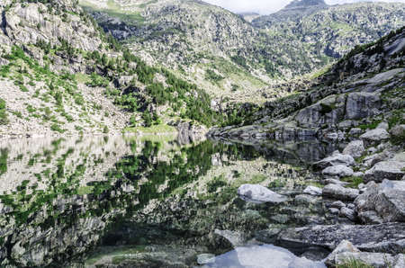 Beautiful river into the Pyrenees mountains, with peaceful water.の写真素材