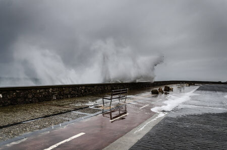 Beautiful shot of a splashing wave in Getaria city, right before the storm.の写真素材
