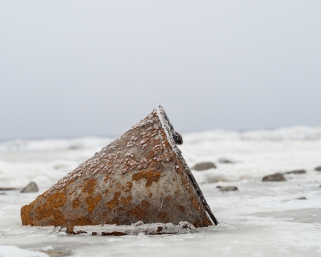 rusty zinc bucket  become frozen in to iceの写真素材