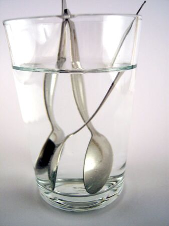 spoons in a glass of waterの写真素材