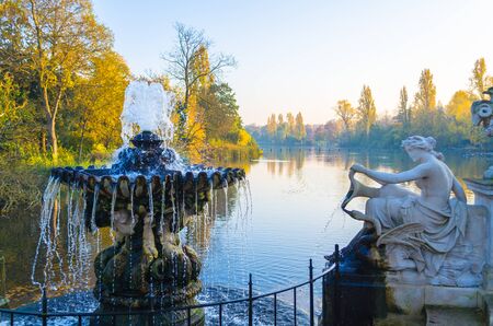 Fountain and sculpture by a pond at Hyde Park, Londonの写真素材