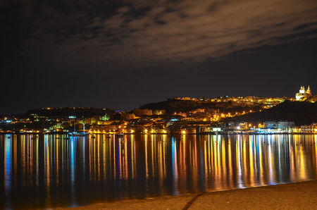 Shining city on a hill - Mellieha Bay at night, Maltaの写真素材