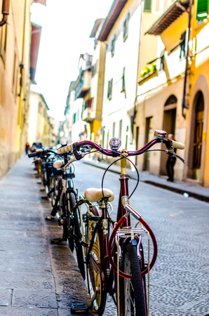 Bicycles parked on a street in Florence, Tuscanyの写真素材