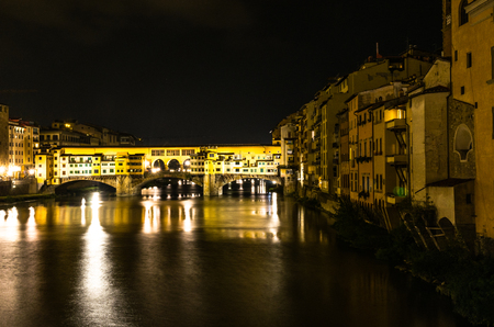 Ponte Vecchio on the Arno River by night in Florence, Italyの写真素材