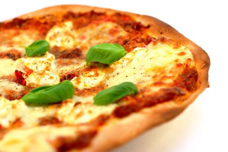 Homemade thin crust pizza on a white background. Narrow depth of field.の写真素材