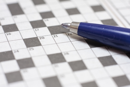 A close-up image of a ballpoint pen on a blank crosswordの写真素材