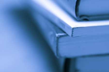 A close-up of a stack of books in a blue toneの写真素材