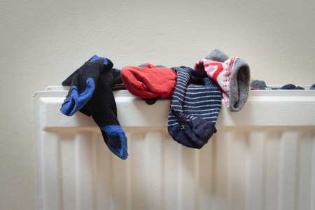 Socks drying on top of a radiatorの写真素材