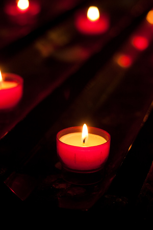 Brightly burning votive candlesの写真素材