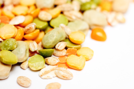 Close-up of dried lentils, peas and barley on a white backgroundの写真素材