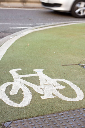 A typical UK cycle lane with green tarmacの写真素材