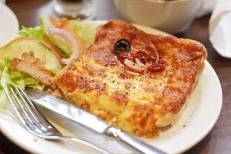 A croque monsieur sandwich with a side saladの写真素材