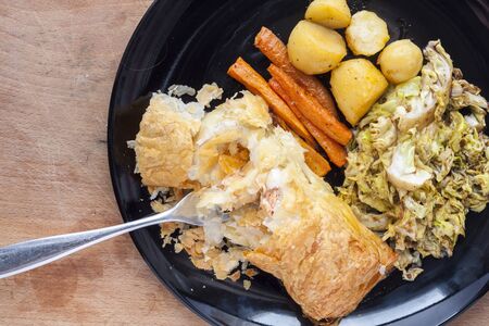 Salmon en croute, with vegetables, served on a black plateの写真素材