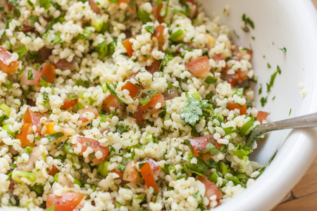 Fresh tabbouleh, a Middle Eastern salad, in a white bowlの写真素材