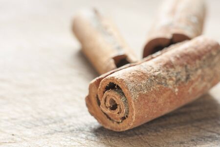 Close-up of cinnamon sticks on a wooden surface