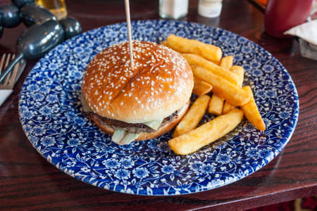 Burger and chips on a blue plateの写真素材