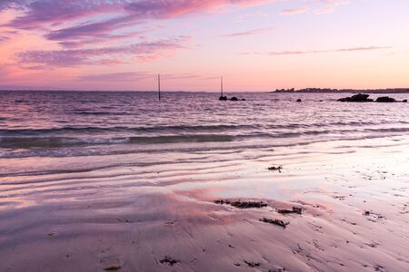 Fiery skies during sunset at Plage de Kervillen, Brittany, France.の写真素材