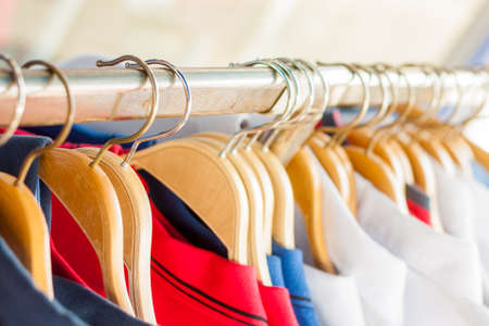 Clothese rail full of clothes on hangersの写真素材