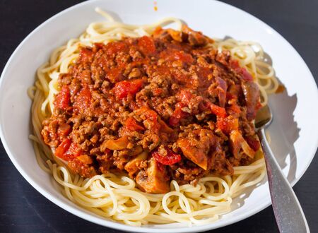 Classic Spaghetti Bolognese in a white pasta bowlの写真素材