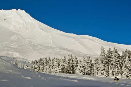 Solo hiking through the mountain snow.の写真素材